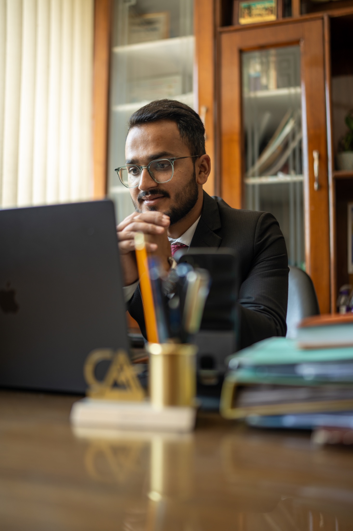 CA Anuj Singh Bhandari advising from his office desk